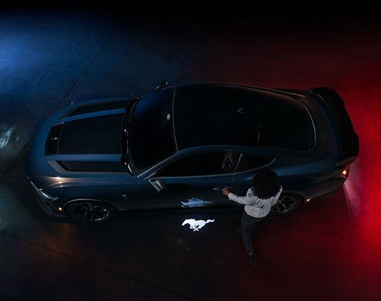 2024 Ford Mustang® Dark Horse™ model with a driver approaching the vehicle | Davis Ford Sales, Inc. in Fulton MS